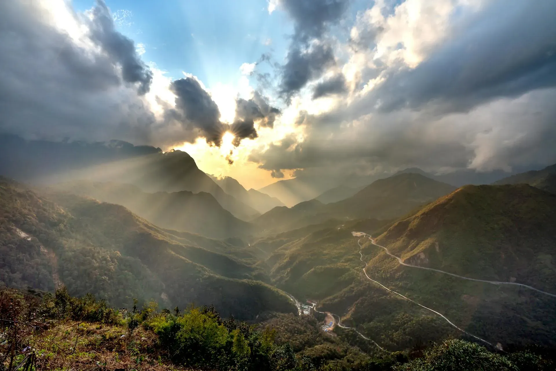 The sun shining through clouds over a mountainous valley. Signifies a fresh start for the new year!
